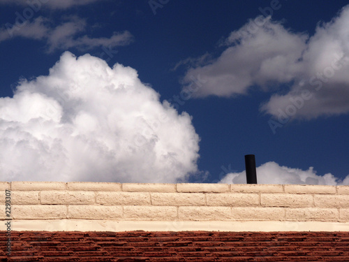 brick wall clouds and blue sky