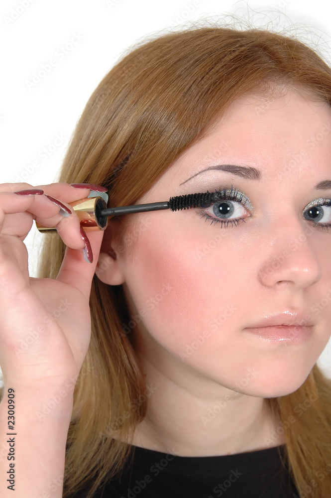 beautiful girl fixing eyelashes