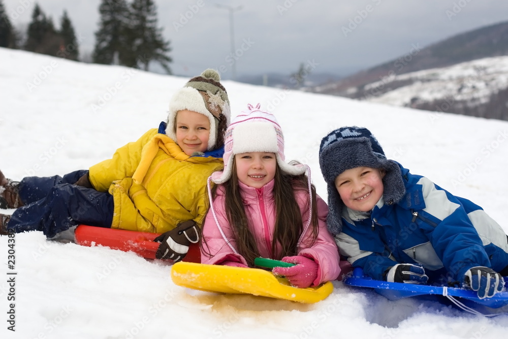 kids sliding on fresh snow