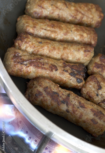 cooking sausages in a pan