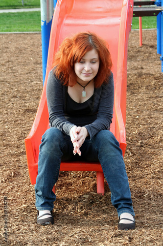 teen reminiscing at playground vertical