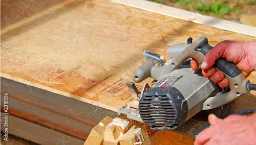 construction worker sawing wood
