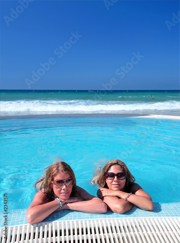 two attractive young girls in a swimming pool on t © Nick Stubbs