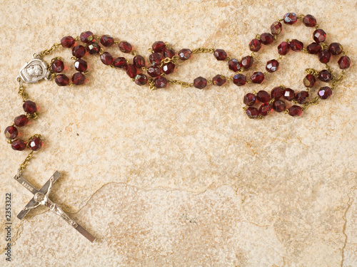 rosary beads on stone with copy space photo