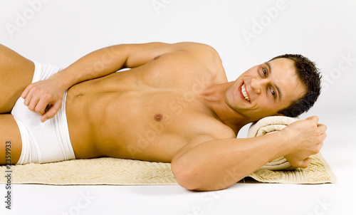 man s lying on the towel