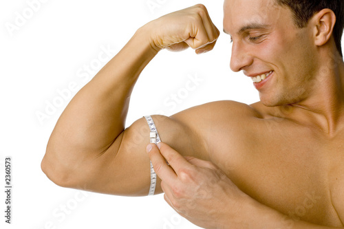 man's mesuring his biceps photo