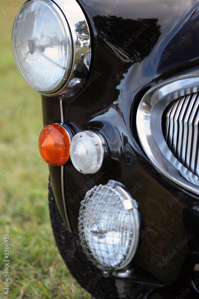detail of classic british car headlight and grille