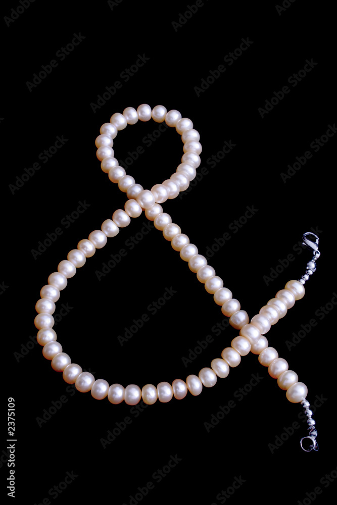 pink pearl's bead as a & sign isolated on black pink pearl's bead as a & sign isolated on black