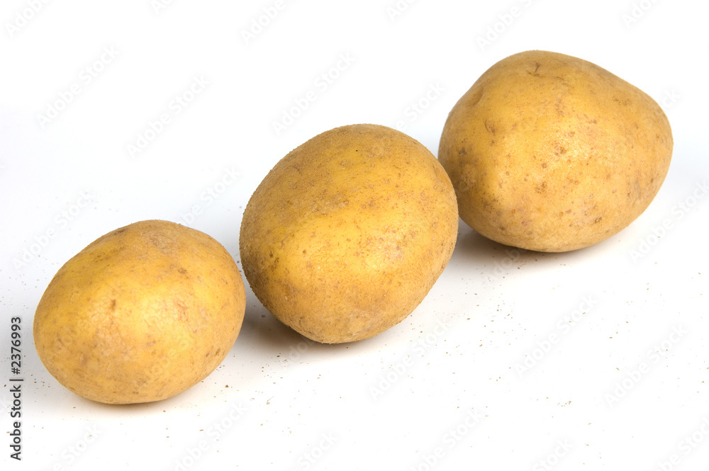 three potatoes diagonally on white background three potatoes diagonally on white background