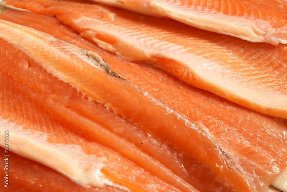 Fresh crude sliced trout filet background close-up.