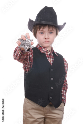 young sheriff boy holding a marshals badge photo