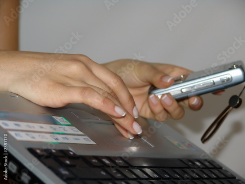 woman working on computer and cellphone