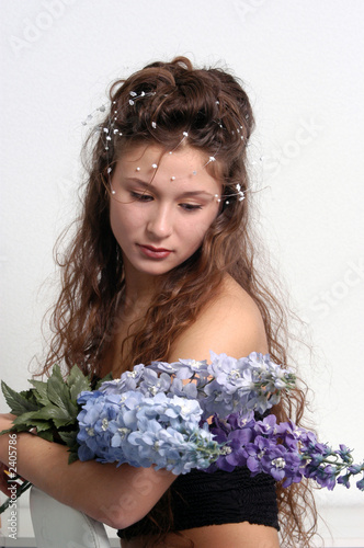 the young girl holds blue flowers photo