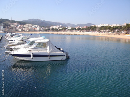 leisure boats in front of beach
