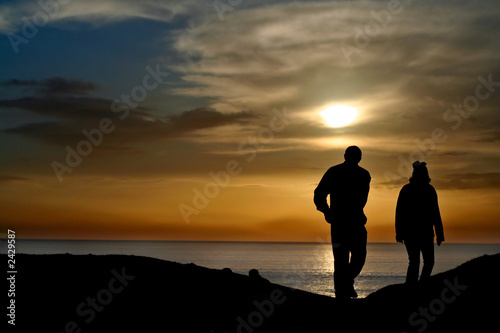 silhouetted couple at sunset
