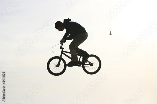 bmx bicycler jumping in the air