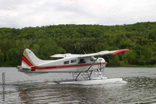 float plane idling away on a calm lake in Quebec Canada