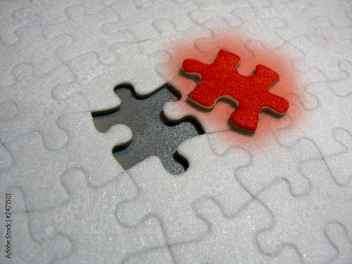 puzzle with glowing red piece