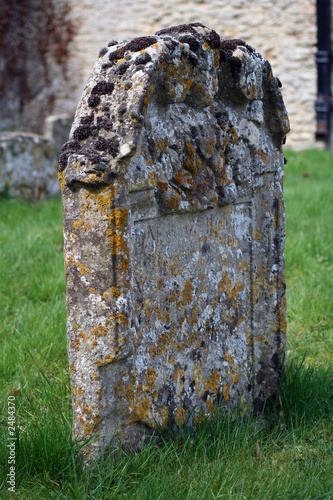a tombstone in an ancient graveyard