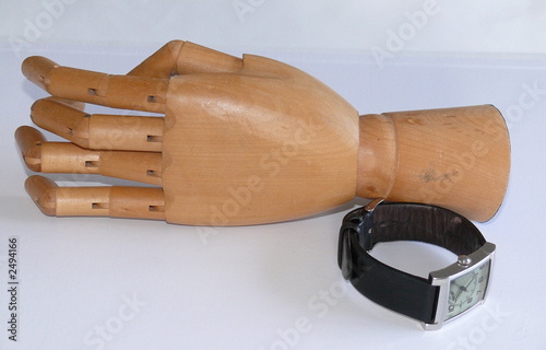 a wooden hand with watch