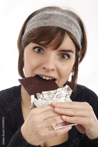 pretty young woman eating chocolate