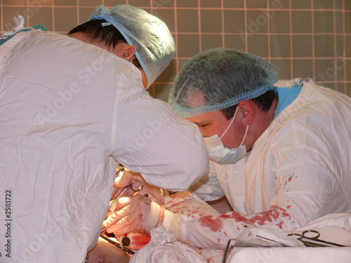 surgical team during operation: working on open wo photo