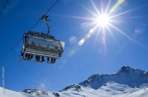 skiers in a chairlift photo