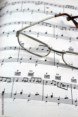 reading glasses on sheet music verticle
