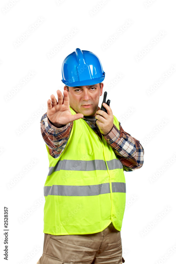 construction worker talking with a walkie talkie and orders to s