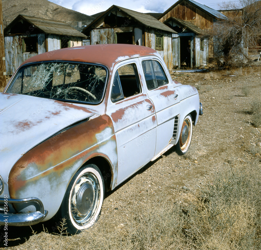 Fototapeta premium old rusty renault dauphine in ghost town