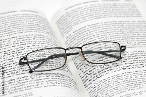 reading glasses with light frame over the open book