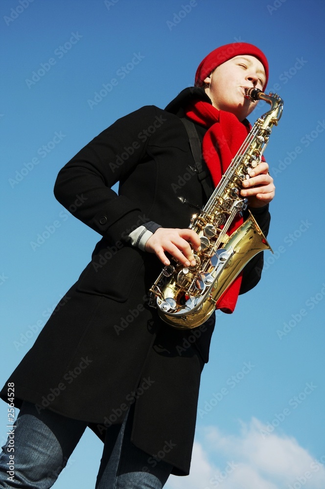 Naklejka premium girl plays on a saxophon