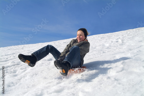 girl sliding down on her sleigh photo