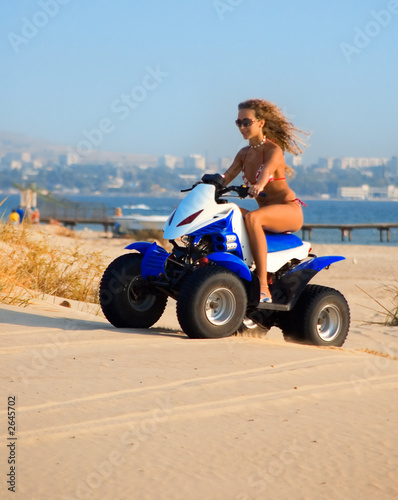 woman on motobike on the beach