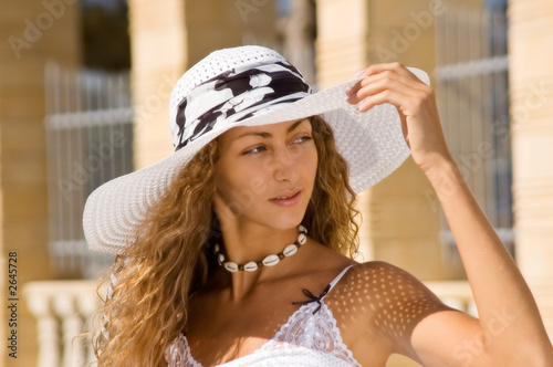young woman in white hat and white summer dress