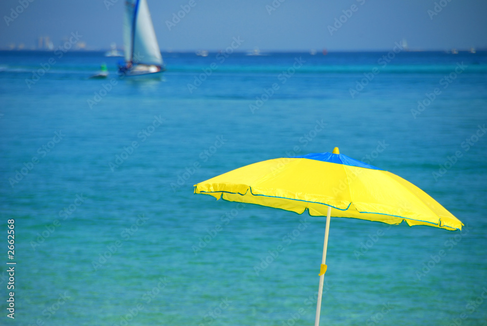 yellow umbrella turquoise sea