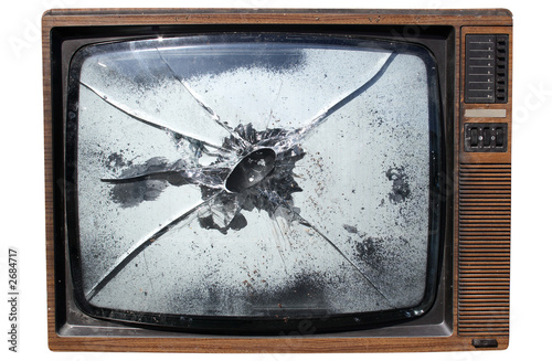 an old trashed tv with a smashed screen.