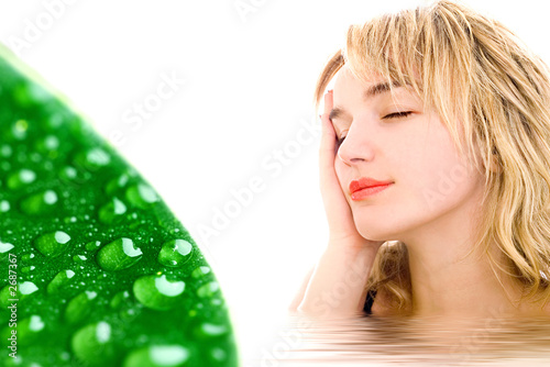 relaxed woman and green leaf with waterdrops