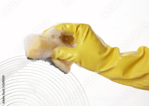 Fototapeta Naklejka Na Ścianę i Meble -  hand in yellow rubber glove with yellow sponge and