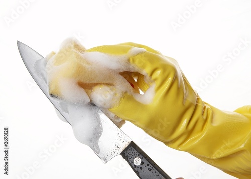 hand in yellow rubber glove with yellow sponge and