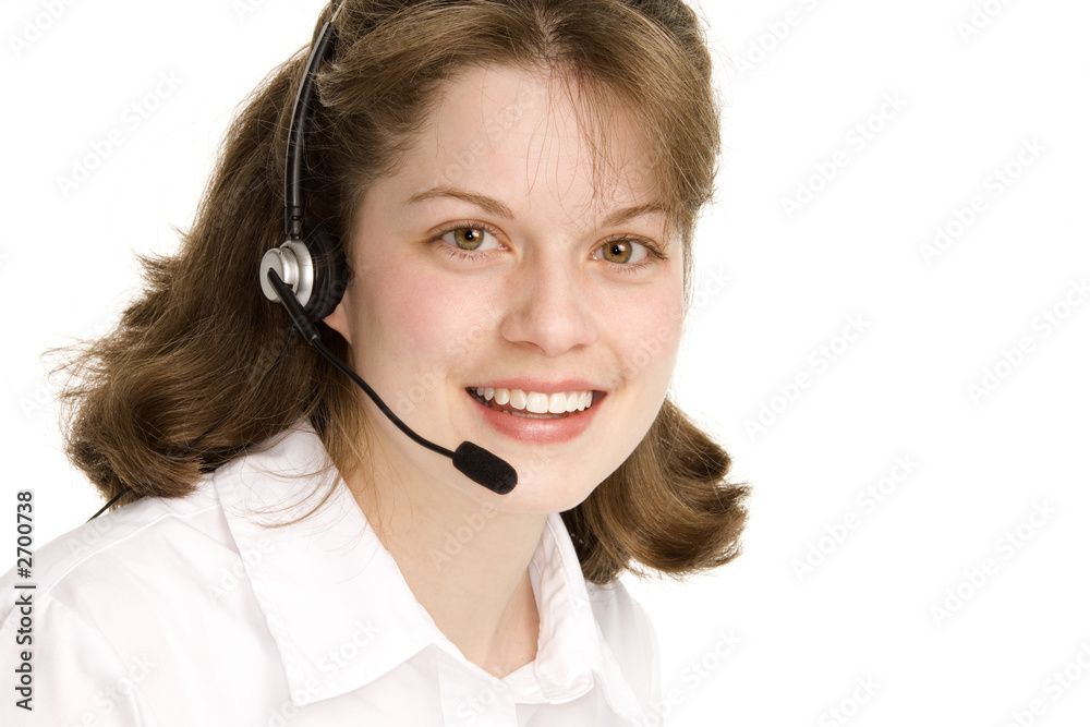 receptionist with headphones, looking at us, smili