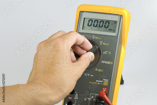 technician adjusting digital meter photo