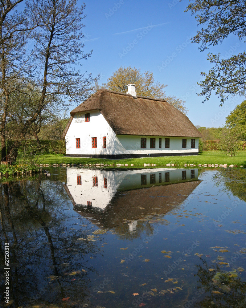 reflection of old house in pond reflection of old house in pond