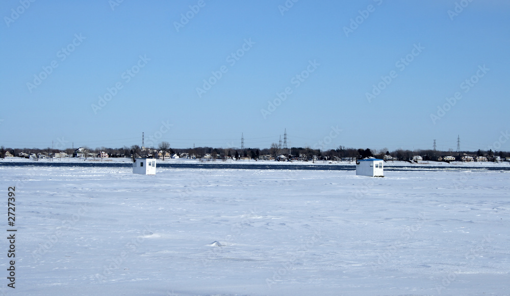 ice fishing huts on a frozen river ice fishing huts on a frozen river