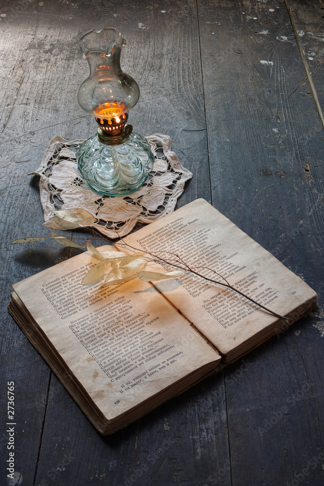 Obraz premium book of poetry and ancient oil lamp