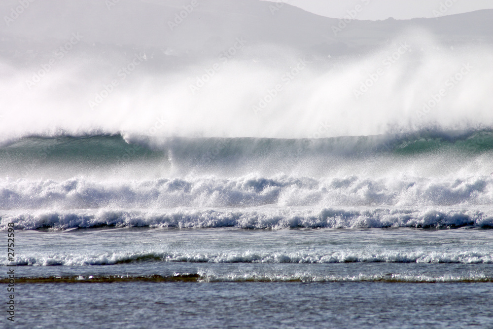 an atlantic wave breaking as it reached the shore. an atlantic wave breaking as it reached the shore.