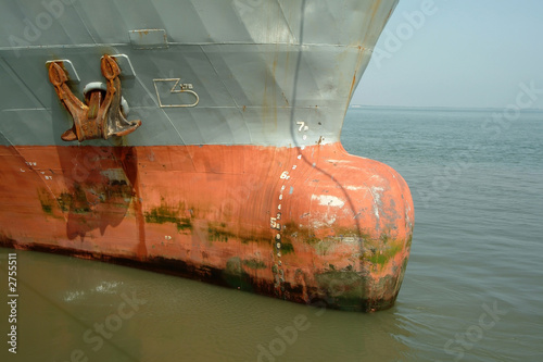 old large rusty ship moored