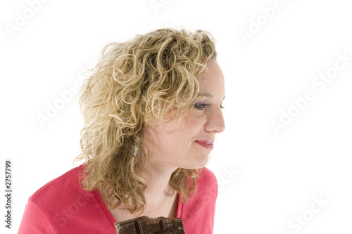 young blond woman eats chocolate