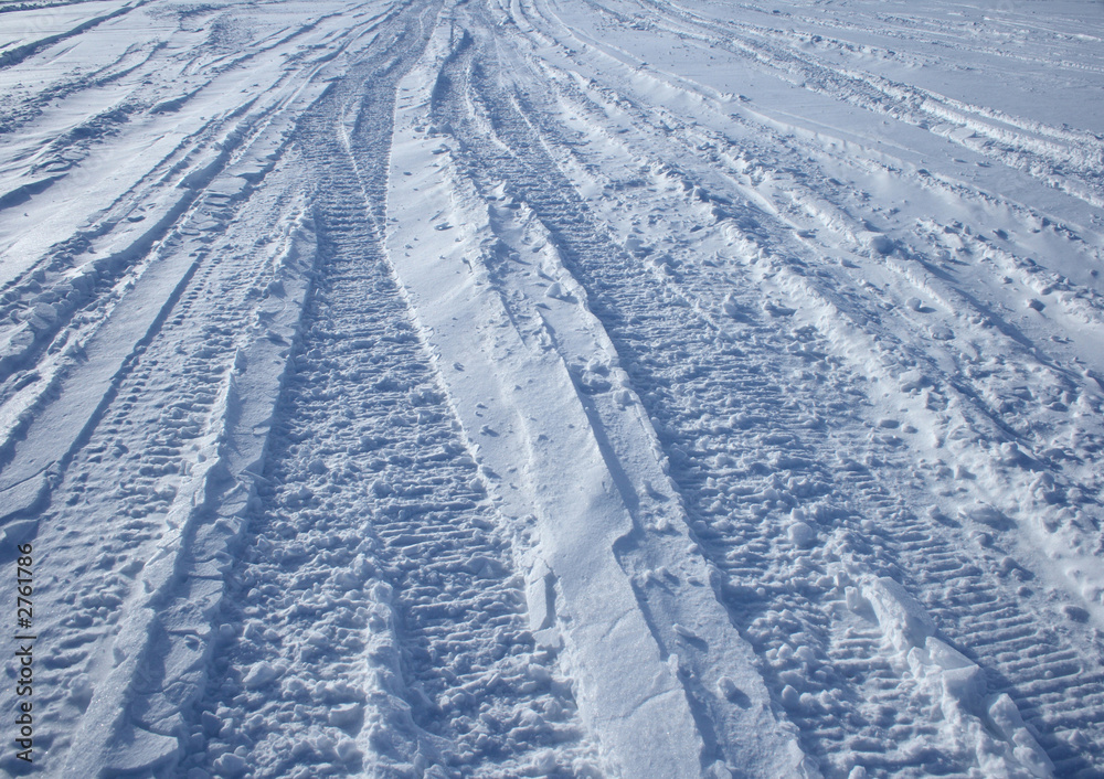 car tracks crossing the snowy terrain