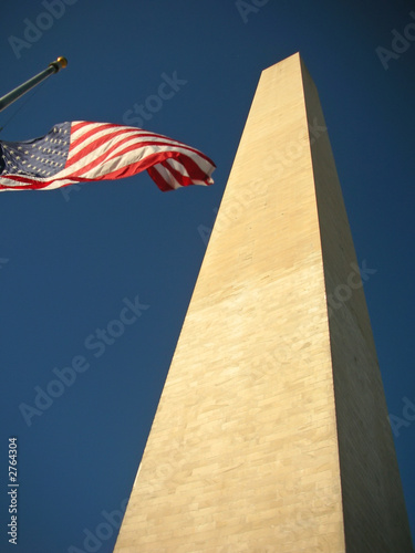 washington monument with the us flag on the national mall photo